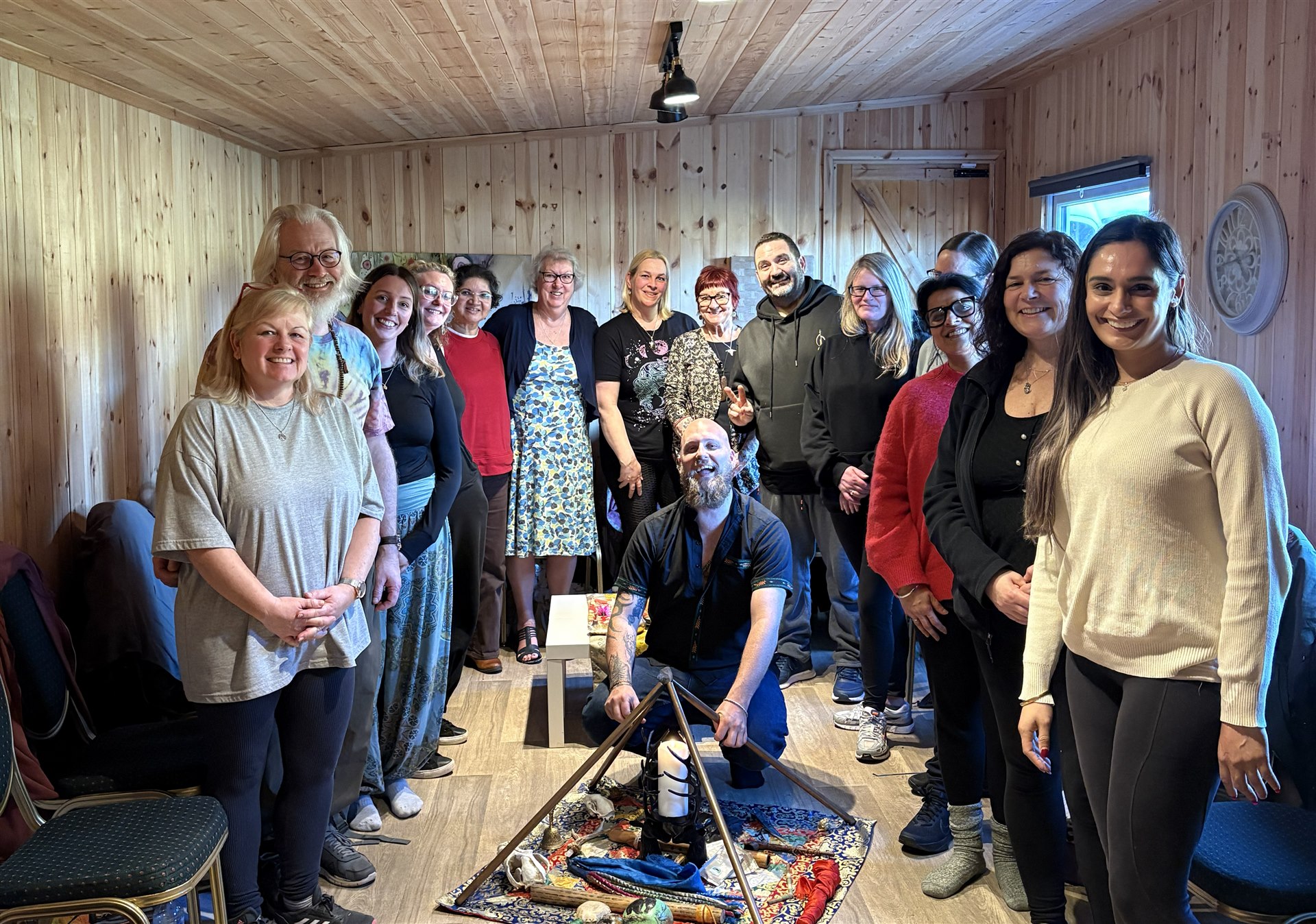 Workshop group in a wood-panelled studio around a central altar